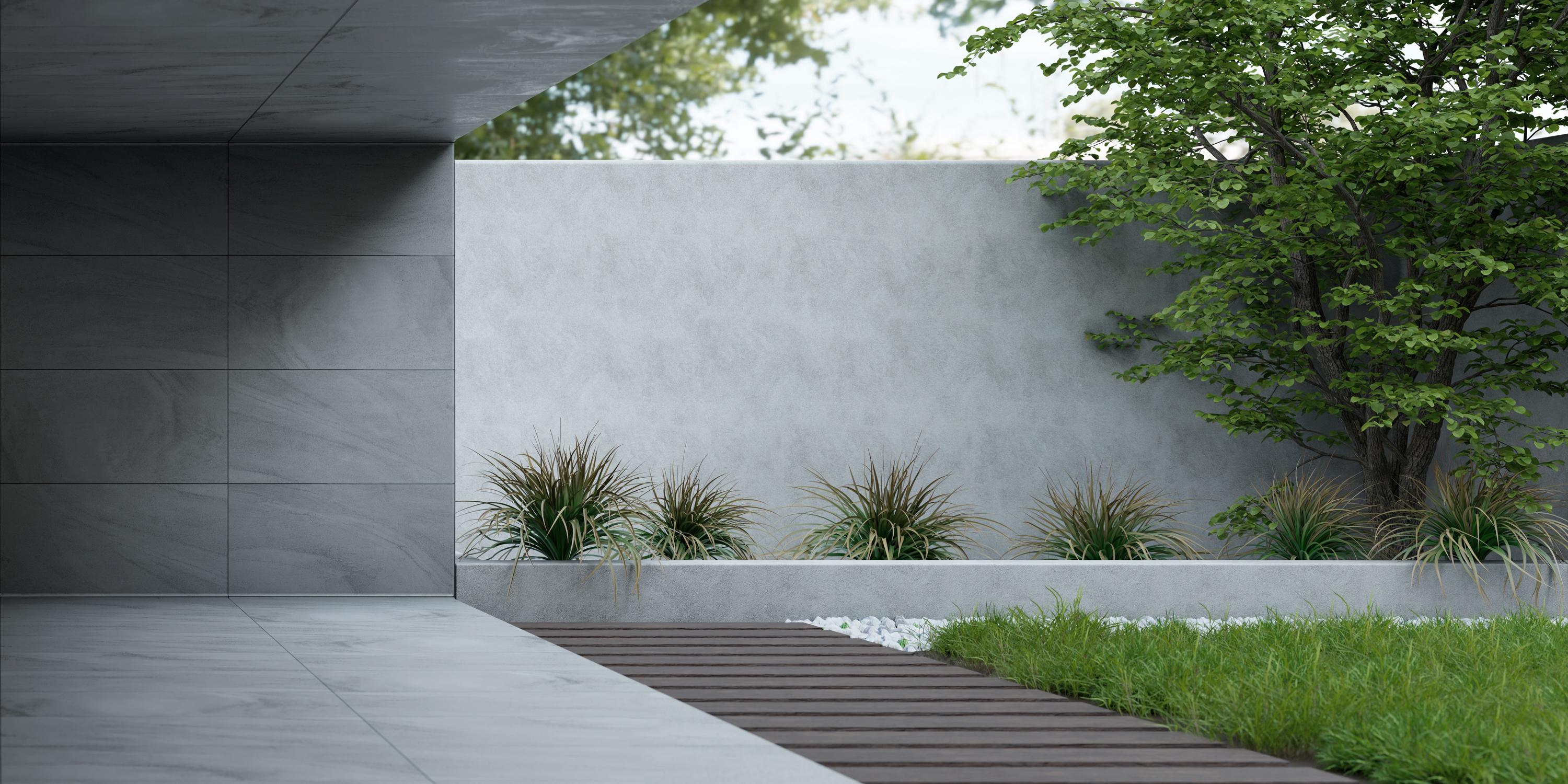 House with grey wall, lawn and plants